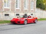 a red sports car parked on the side of the road