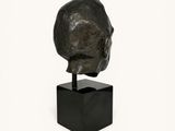 statue of a man ' s head on a black marble base