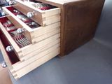 a drawer with silverware inside of it on the floor