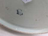a white plate with a tag on it with a picture of a dog