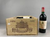 a bottle of wine in a wooden box next to a bottle of wine