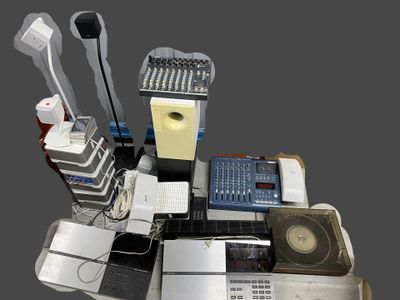 a desk with a lot of electronic equipment on top of it