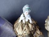a small figurine of a woman sitting on a pillow