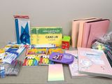 a table with many school supplies and supplies on it