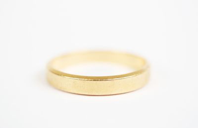 a close up of a gold ring on a white surface