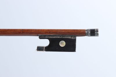 a violin bow that is attached to a piece of wood