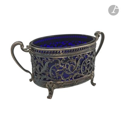 a silver and blue glass bowl sitting on top of a table
