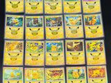 the pokemon cards are lined up on a black surface