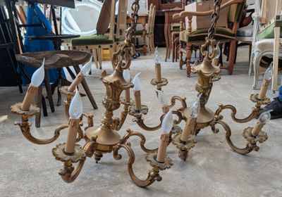 a lot of gold colored chandeliers sitting on the floor
