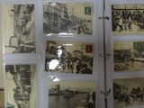 a display of old photos on the wall in the room