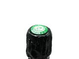 a bottle of wine with a green label on it