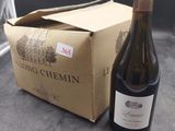 a bottle of wine sitting next to a box of wine