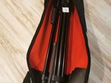 a bag with a tripod in it sitting on the floor