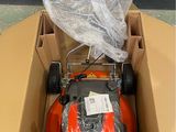 a box with a lawn mower inside of it