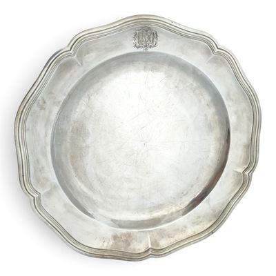 an antique silver plate on a white background with a crown on it