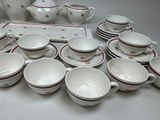 a lot of cups and saucers sitting on a table