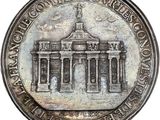 a close up of a coin with a building in the background