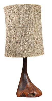 the table lamp is made of wood and has a burlock shade