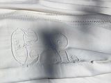 a close up of a white purse with a picture of a cat on it