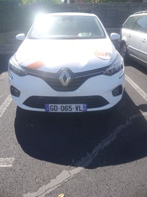 a white car parked in a parking lot next to a silver car