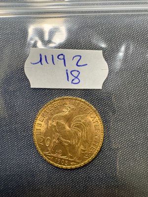 a close up of a gold coin in a clear plastic bag
