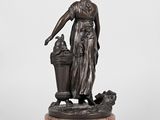 a bronze statue of a woman with a basket on a marble base