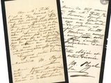 une vieille lettre portant une écriture manuscrite, posée sur une feuille de papier