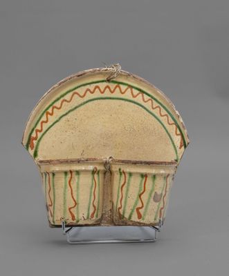 an image of a small bowl on a stand on a gray surface