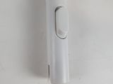 a toothbrush with a wooden handle on a white surface