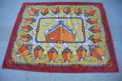 an image of a red and yellow rug with a picture of a man on a horse