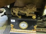 a statue of a lion with a clock on top of it