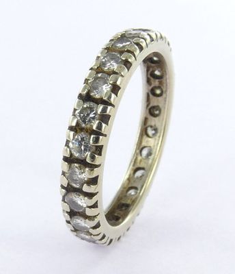 a close up of a diamond ring on a white surface