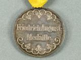 a medal with a ribbon around it on a table