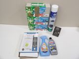 a box of toothpaste, toothpaste paste, toothbrushes, and other cleaning products on a counter