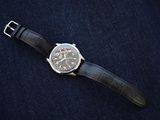 a watch that is laying on a blue cloth