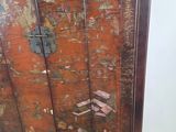 a wooden cabinet with a metal latch on top of it