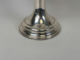 silver plated candle holder on a white table with a white background