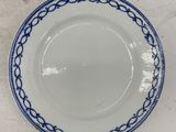 a white plate with a blue rim on a table
