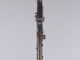 a clarinet with a black body and silver body on a clear stand