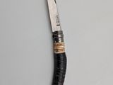 a knife with a black handle sitting on top of a table
