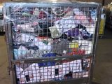 a metal cart filled with lots of clothing in a warehouse