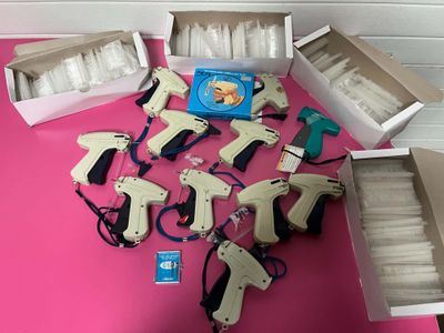 many different types of glue guns on a pink table