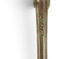 a silver spoon with a handle on a white surface
