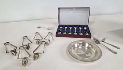 a silver plate with spoons and spoons and a silver plate with spoons and spoons