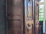 a large wooden cabinet in the corner of a room