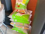 a pile of chips and a bag of chips next to a tv
