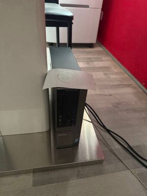 a computer sitting on top of a table in a room