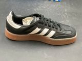 the adidas sneakers are black and white with a light brown sole