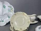 several different types of porcelain dishes and saucers on a table