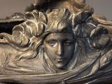 a statue of a woman with a flower in her hair